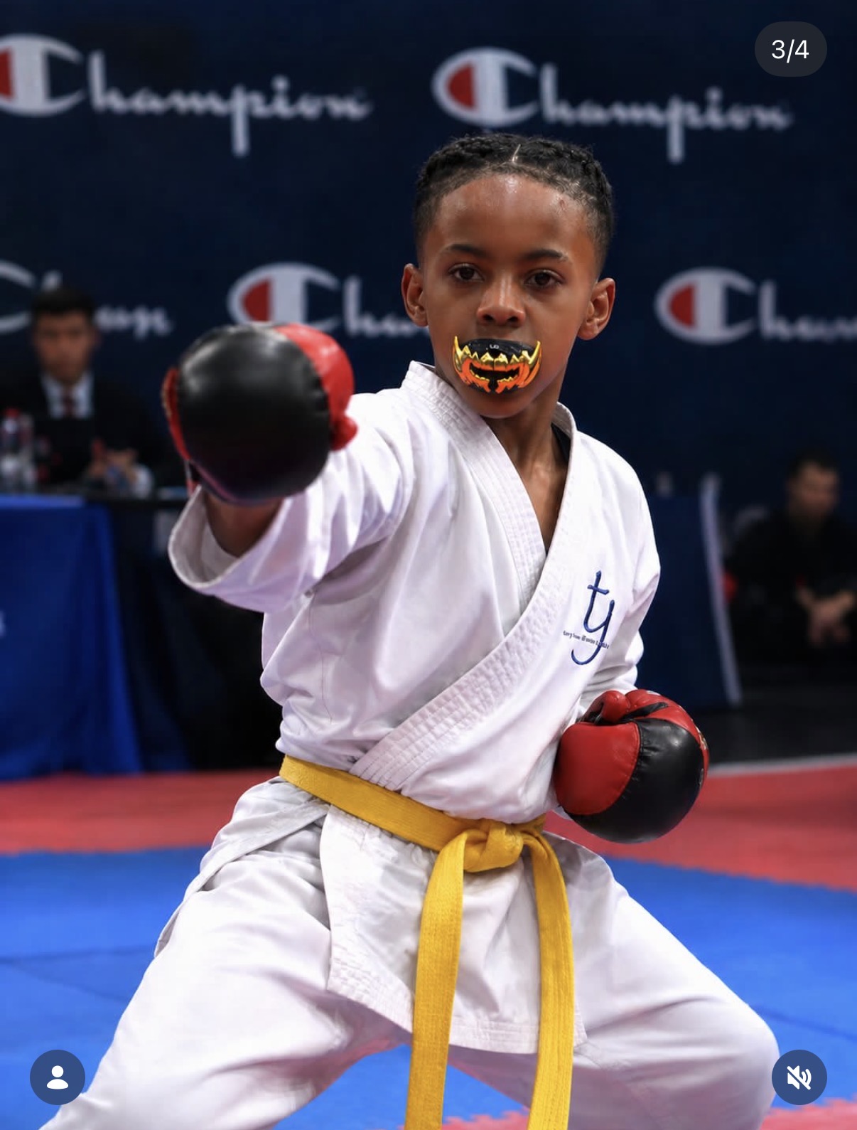 Champ in a fighting stance with yellow belt at a karate tournament